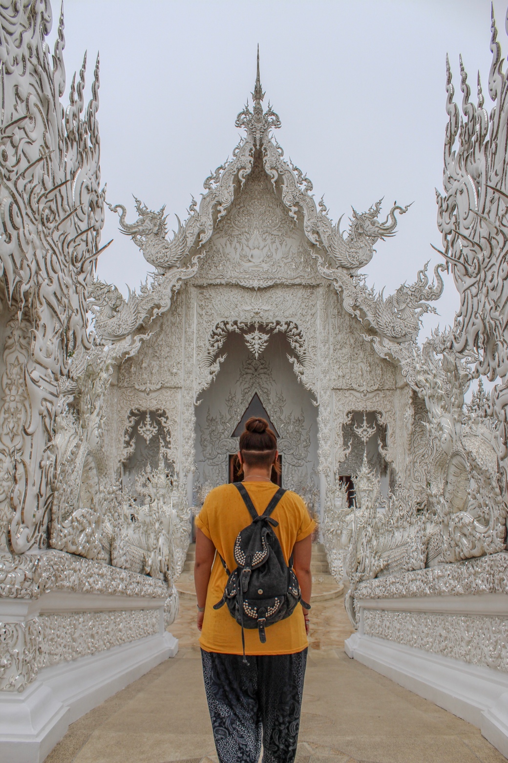 Steff walking across the bridge to enter The White Temple (Wat Rong Khun) in Chiang Rai, Northern Thailand